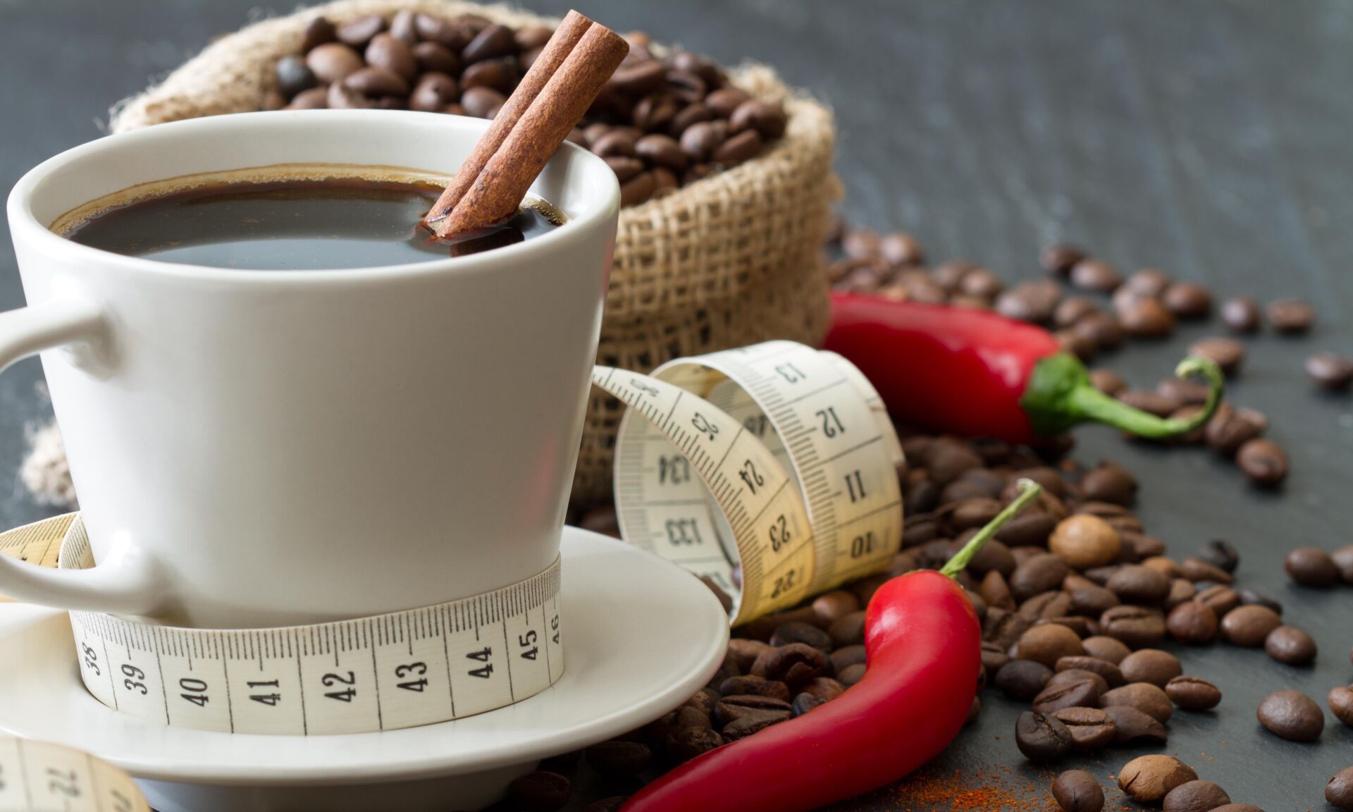 Spicy coffee with chili pepper and cinnamon with tape measure, n