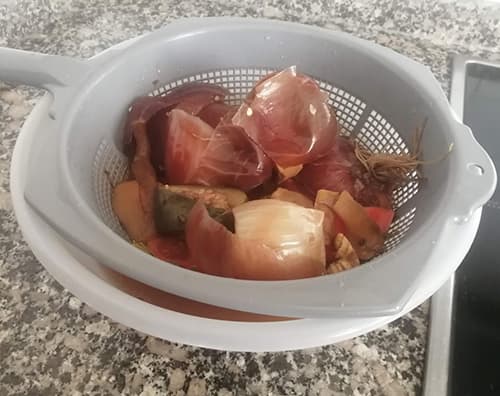 Homemade Healing Broth from Vegetable Scraps -straining the scraps