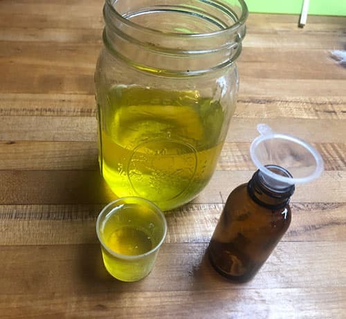 pouring tincture in dropper bottle