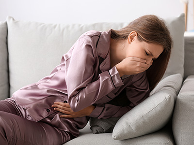 Pregnant woman suffering from toxicosis at home