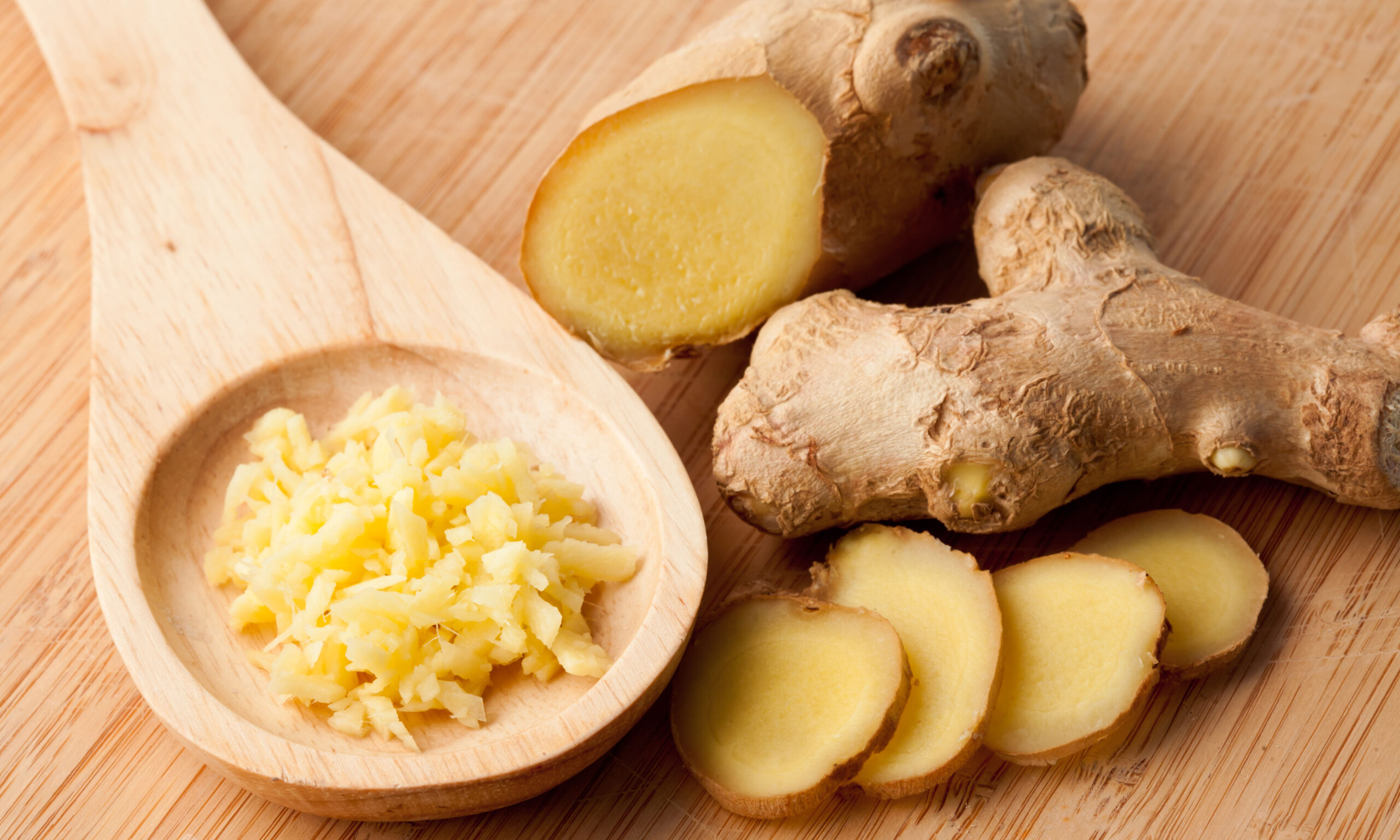 Different forms of ginger against a wood worktop