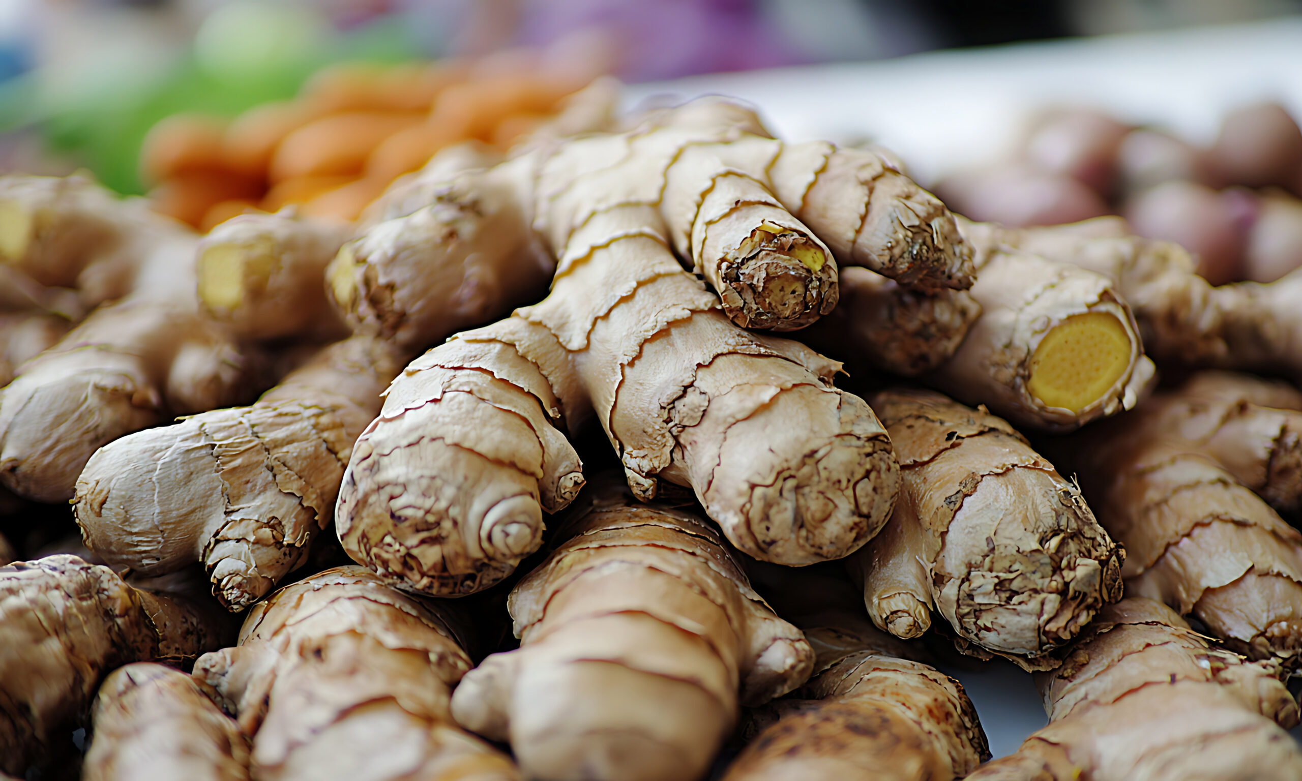 Close-up macro image of raw ginger root placed on white seamless backdrop, shot with 50mm prime lens, detailed focus on knobby surface texture and warm natural colors