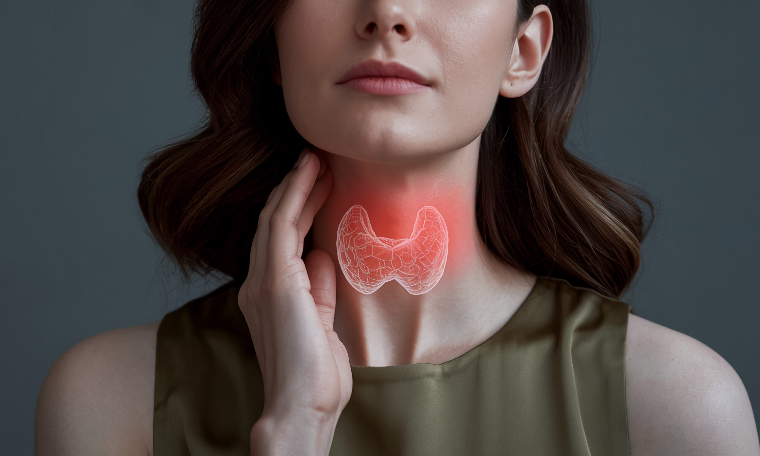 Woman's neck with highlighted thyroid gland, illustrating medica