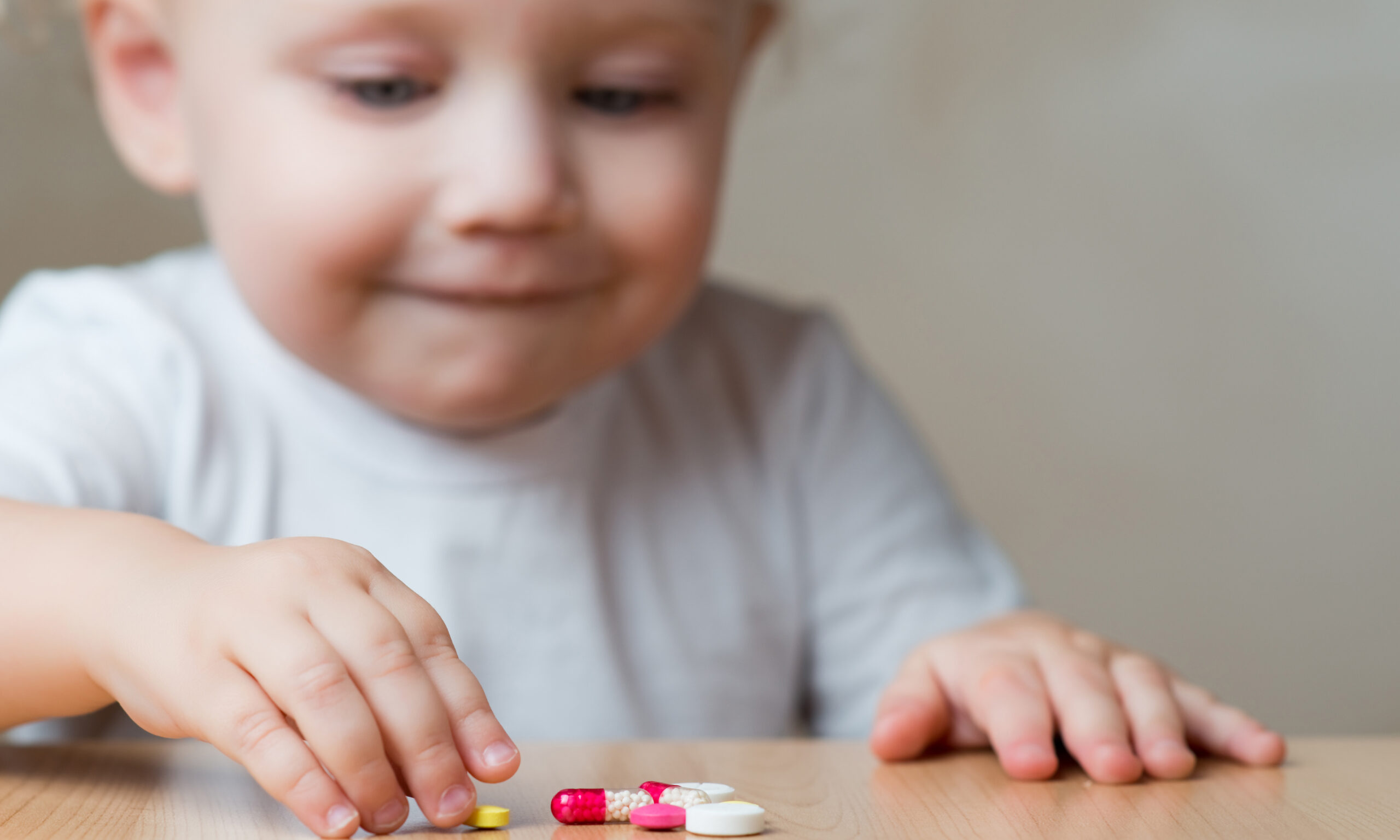 little girl and pills left by adults