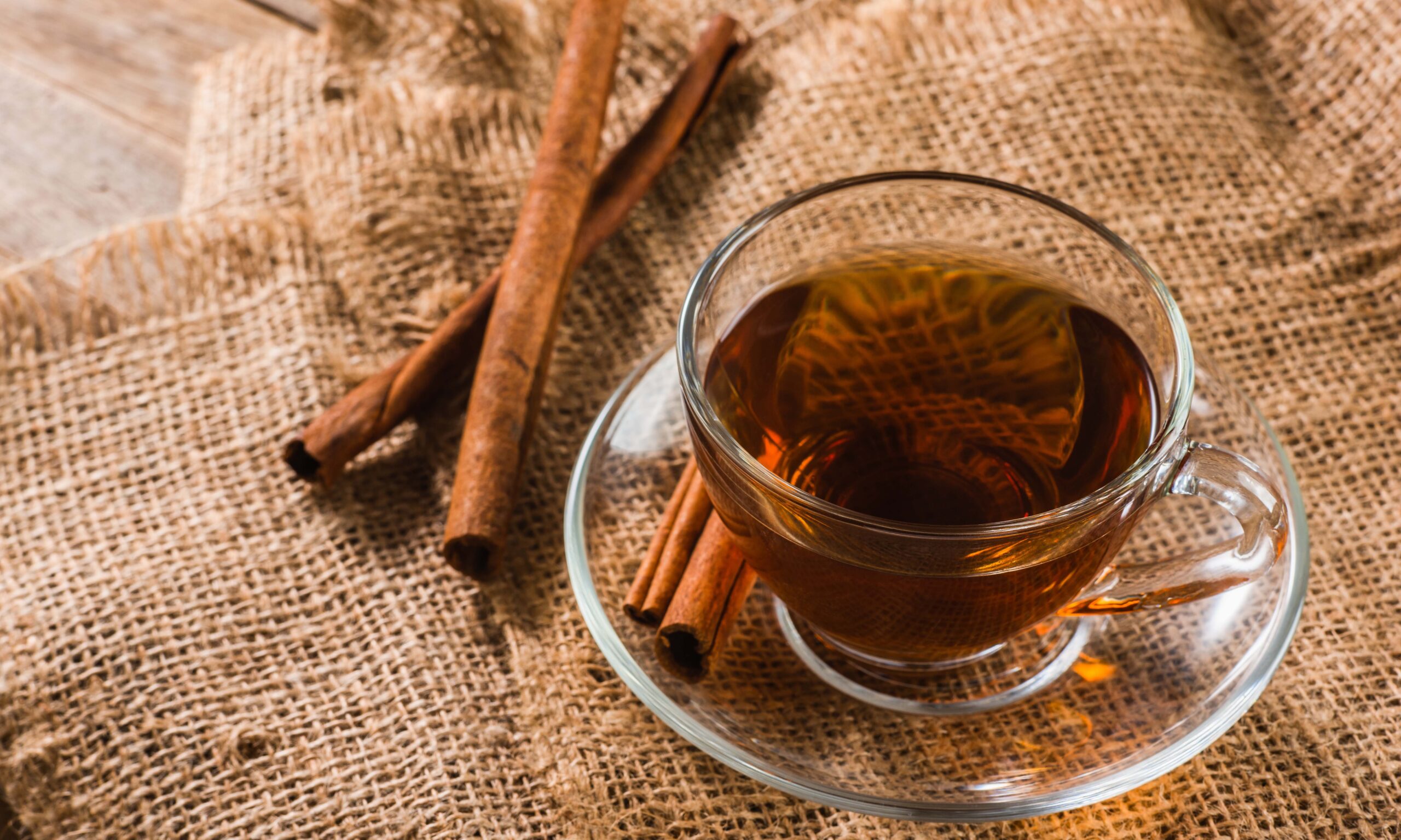 a cup of cinnamon tea on sackcloth