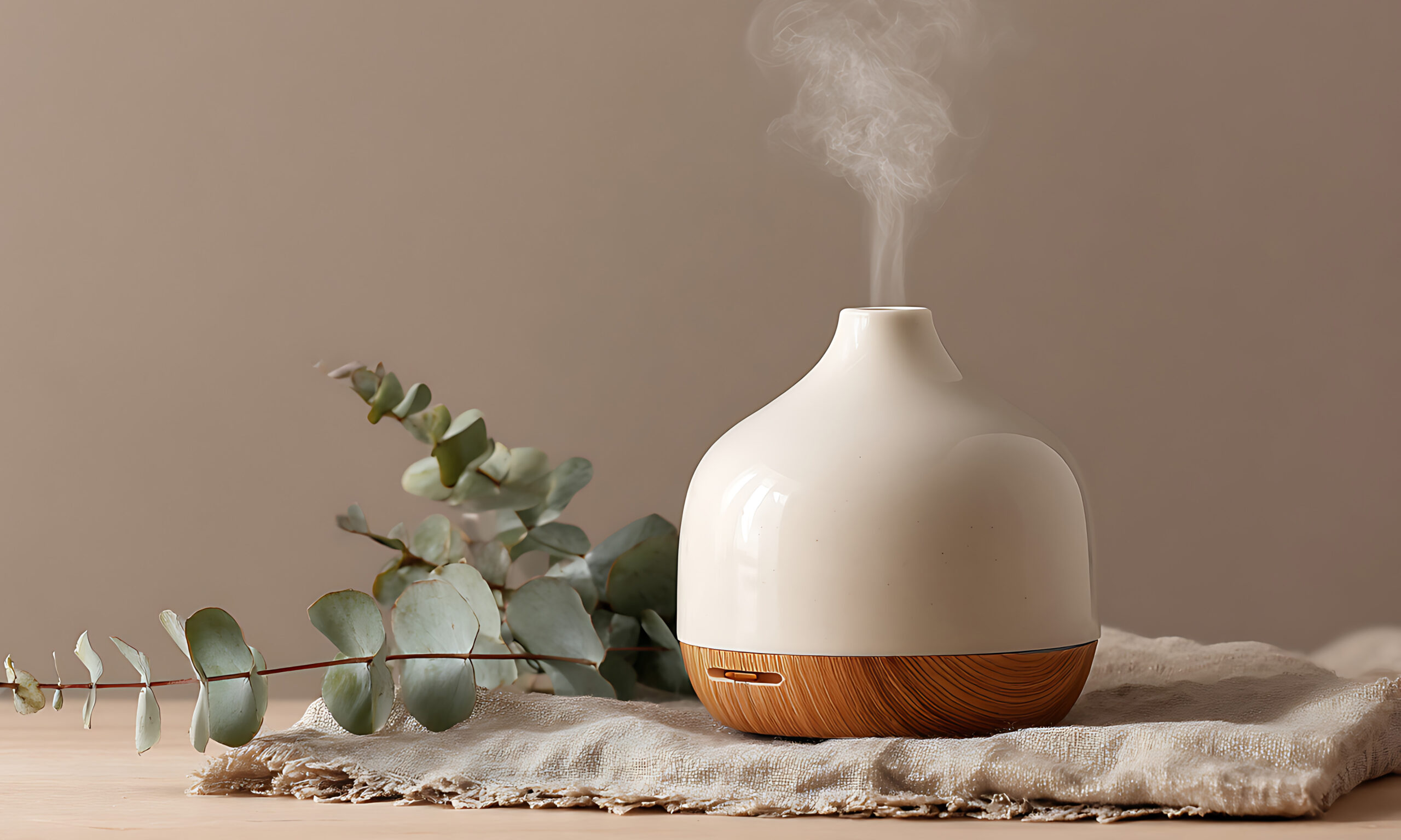 Minimalist spa setting featuring a white ceramic essential oil d