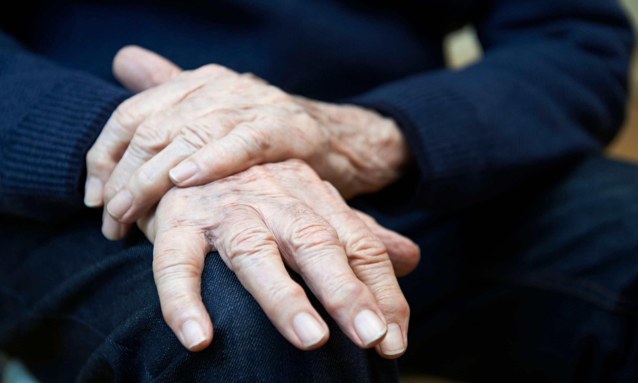Close Up Of Senior Man Suffering With Parkinsons Diesease