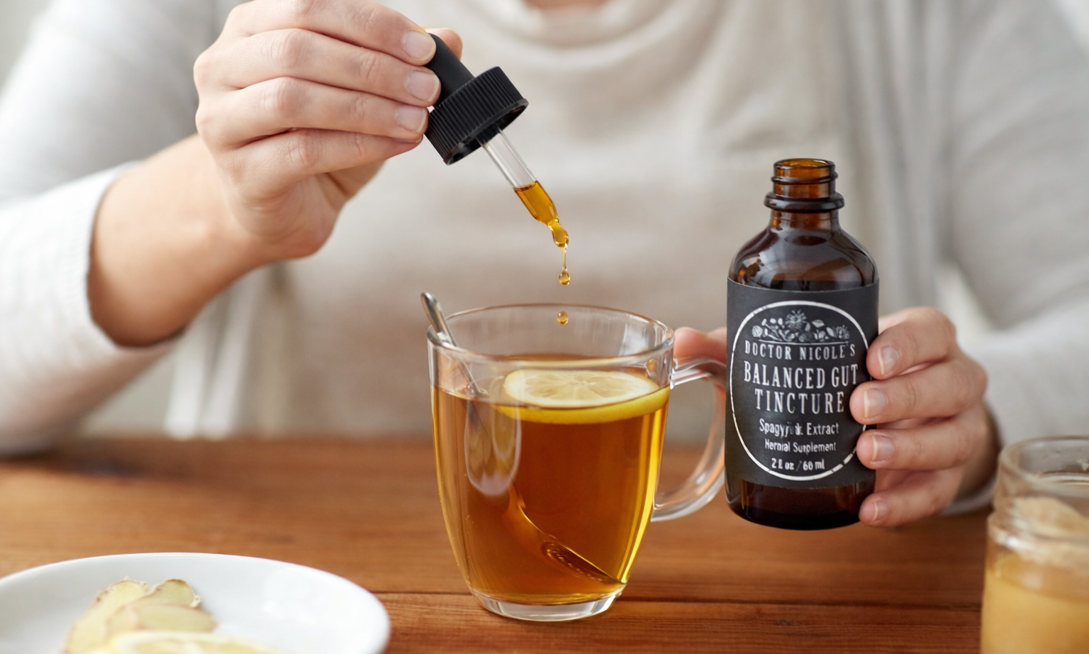 Woman Using Balanced Gut Tincture in Tea