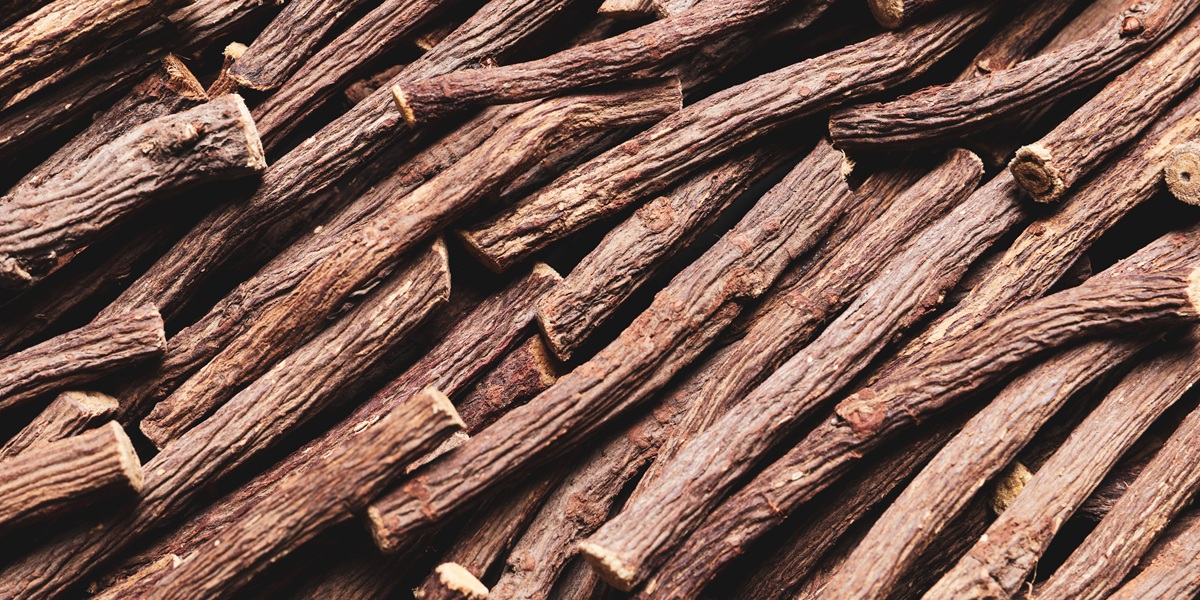 Dried sticks of liquorice root as background, top view