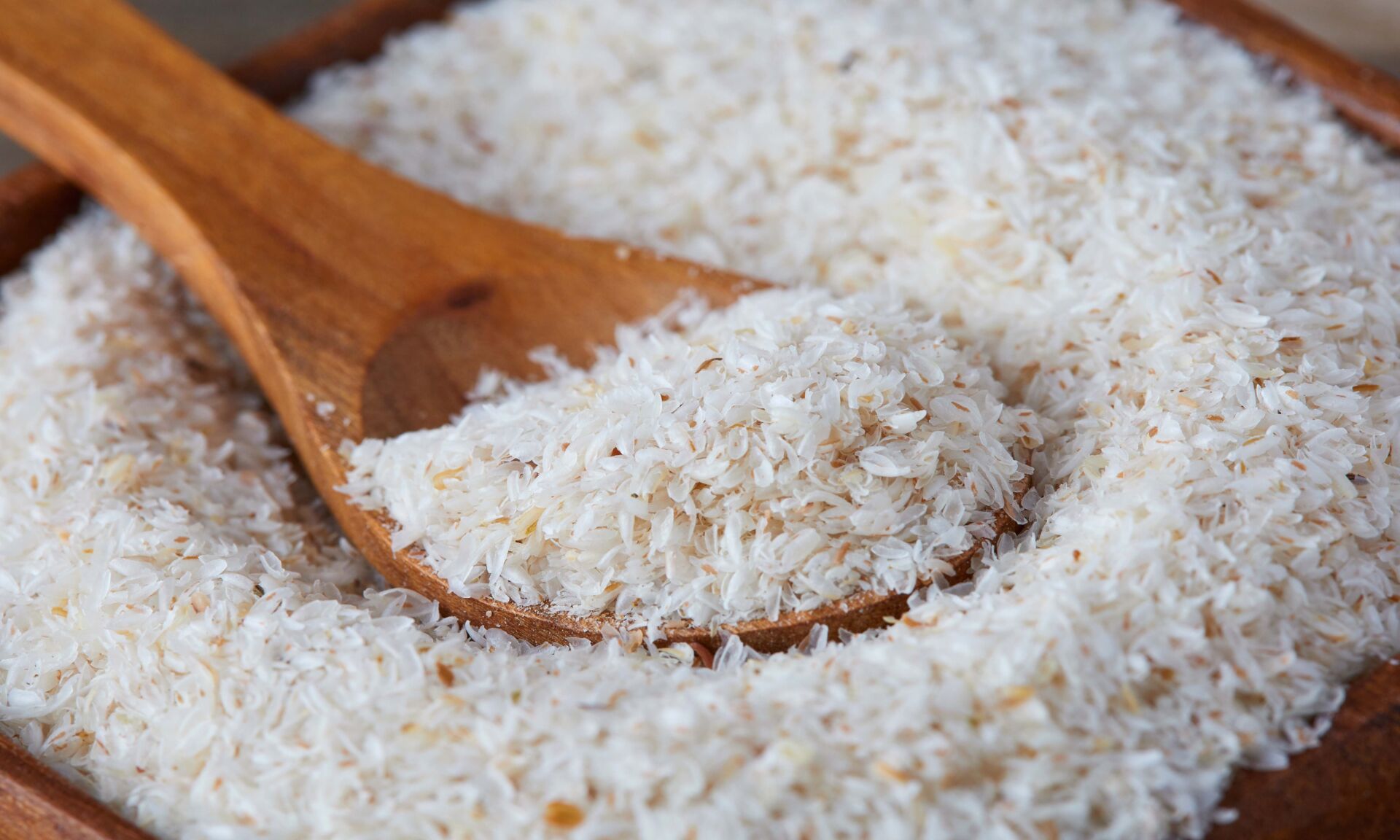 Close up of psyllium (ispaghula) husk in wooden spoon