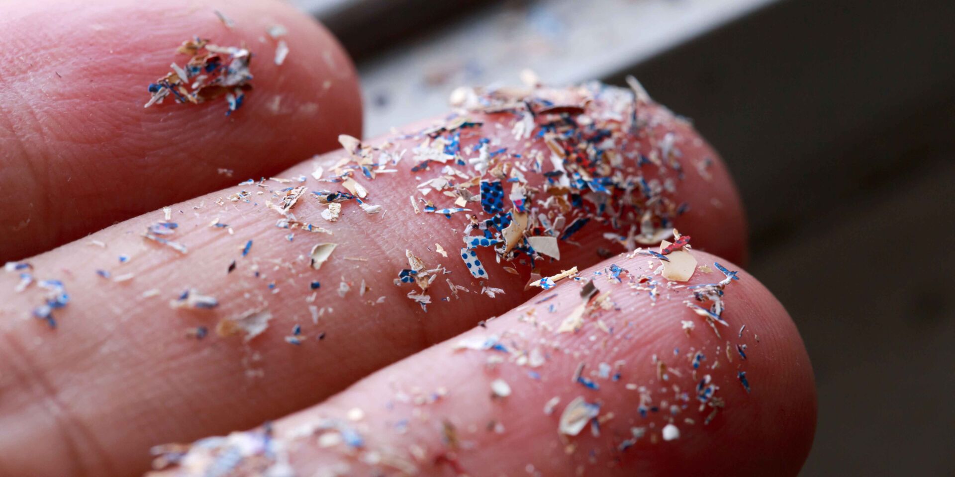 Close up side shot of microplastics lay on people hand.Concept of water pollution and global warming. Climate change idea.