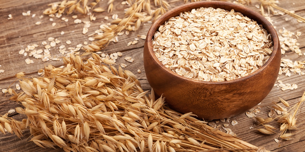 oat flakes in a bowl on the old board.